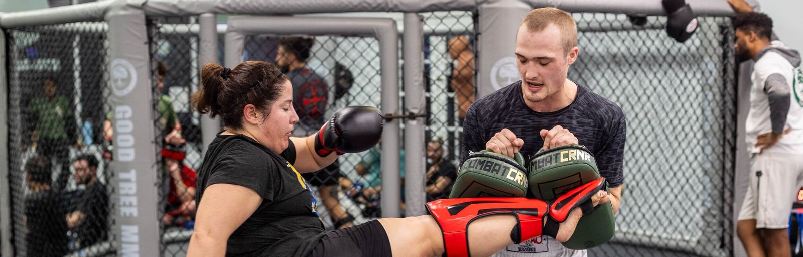 a young woman practices martial arts training with a coach