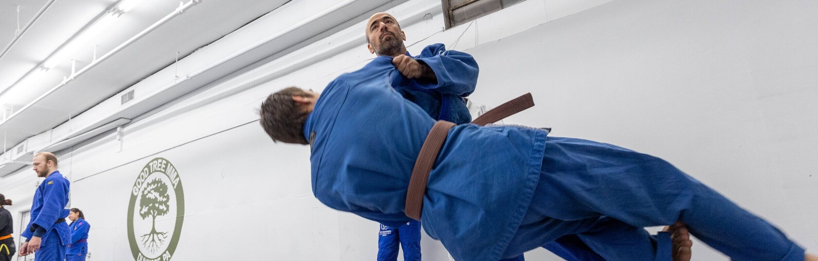 one man tosses another in a judo move in classes in the Dunmore area
